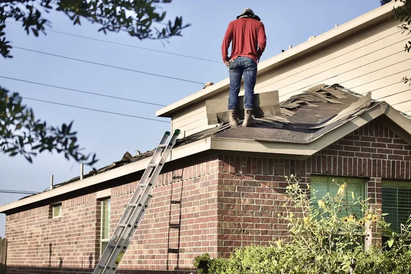 Professional roofer working on a residential roof in The Crossing at Ruidosa